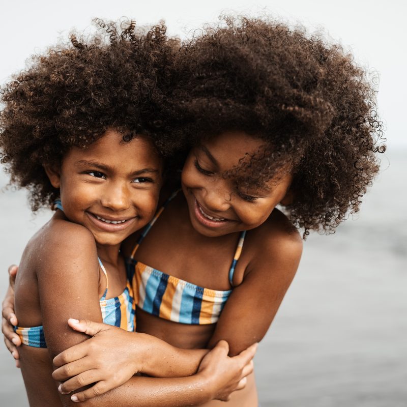 Happy African children having fun on the beach during summer holidays